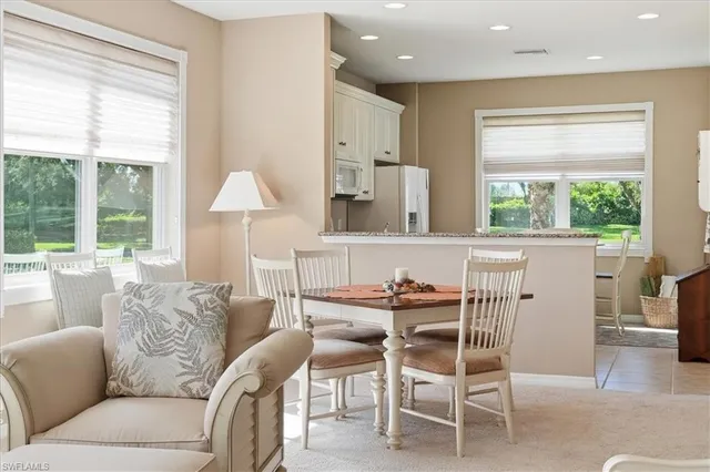 a dining room with furniture and a window