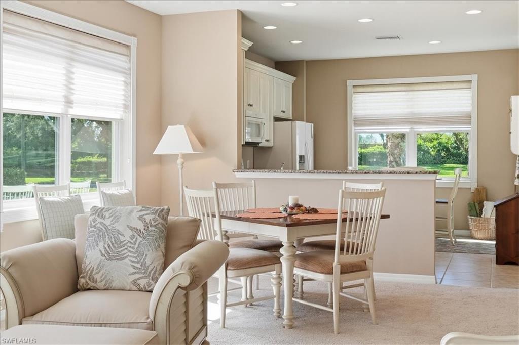 7933 Guadiana Way Ave Maria, FL 34142 - Photo 14 of 50 a dining room with furniture and a window