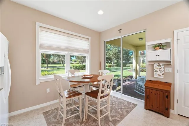 a living room with furniture a flat tv screen and large windows