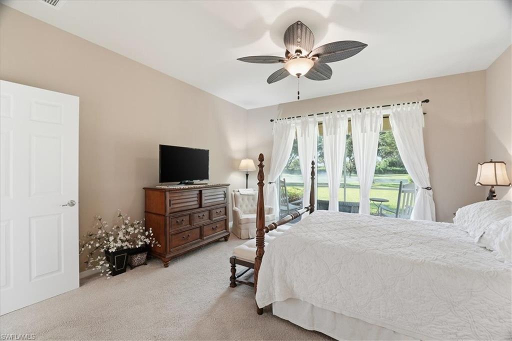 7933 Guadiana Way Ave Maria, FL 34142 - Photo 22 of 50 a bedroom with a bed and a flat screen tv