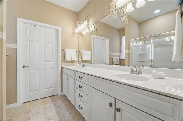 a spacious bathroom with double sink and a mirror