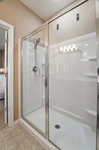 a bathroom with a glass shower door