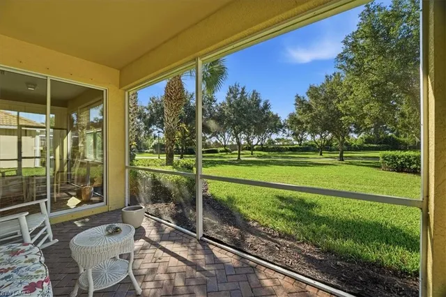 a view of a porch with furniture and garden