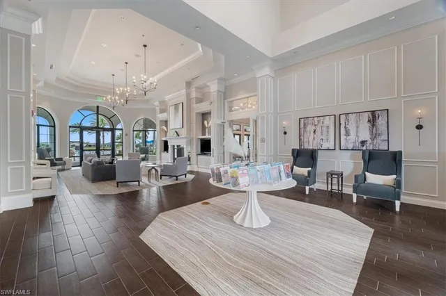 a living room with lots of furniture and view of kitchen