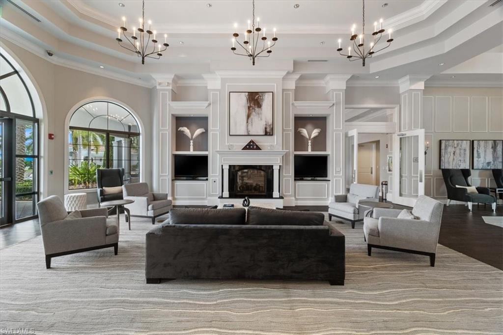 7933 Guadiana Way Ave Maria, FL 34142 - Photo 38 of 50 a living room with furniture fireplace and large windows