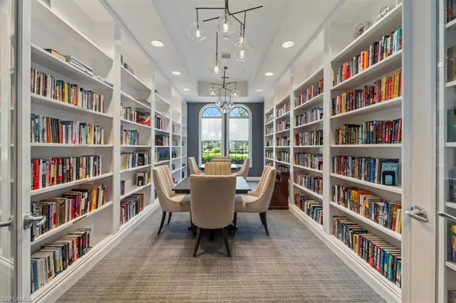 a living room with a book shelf and a book shelf