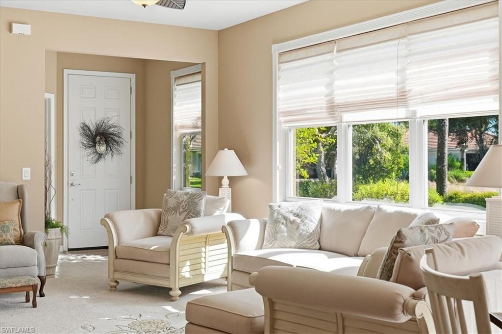 7933 Guadiana Way Ave Maria, FL 34142 - Photo 9 of 50 a living room with furniture and a large window