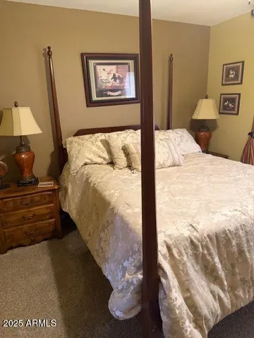 a bedroom with a bed and a potted plant