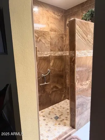a bathroom with a glass shower door