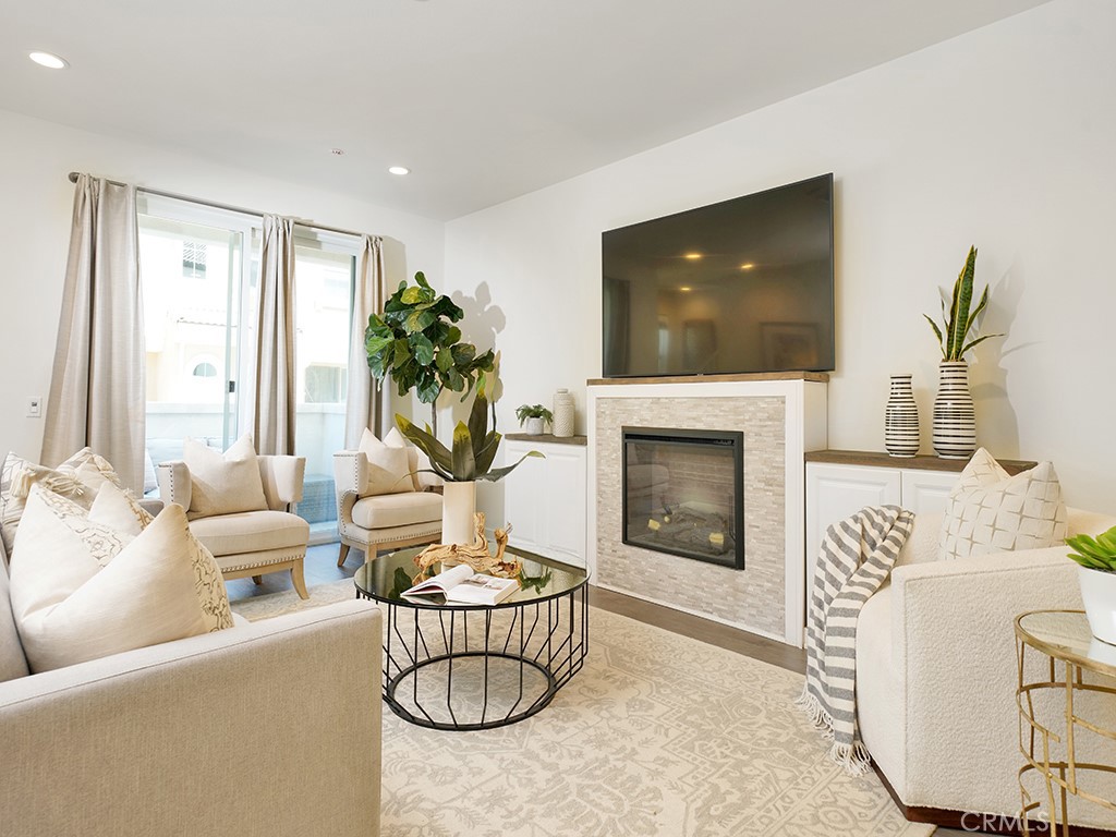 a living room with furniture and a fireplace