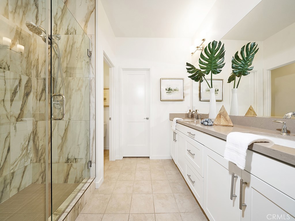 603 Shadowbrook Lake Forest, CA 92610 - Photo 13 of 23 a bathroom with a granite countertop sink a mirror and a shower