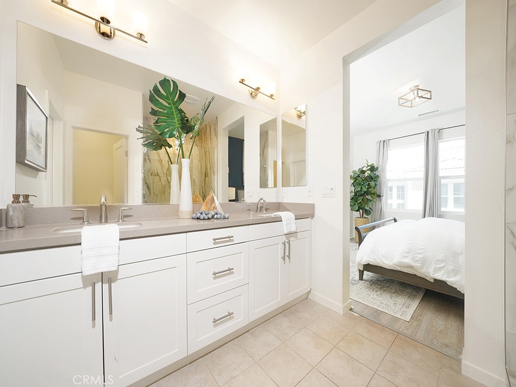 603 Shadowbrook Lake Forest, CA 92610 - Photo 14 of 23 a en suite bathroom with a double vanity sink and a mirror