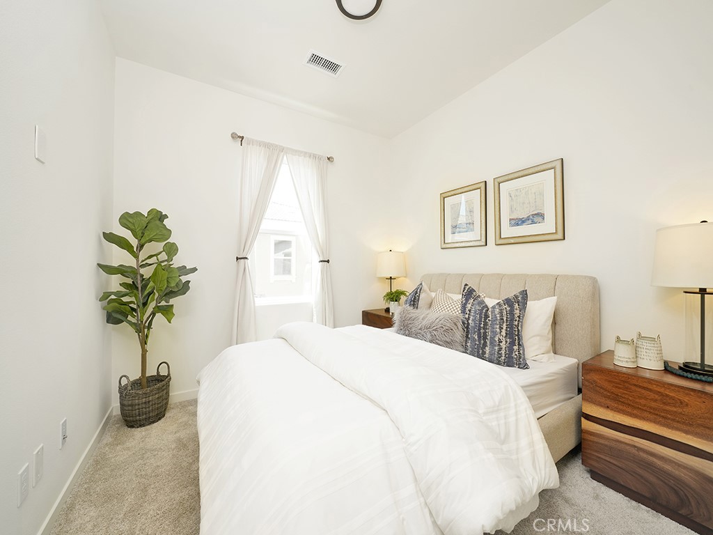 603 Shadowbrook Lake Forest, CA 92610 - Photo 16 of 23 a bedroom with a bed and a potted plant