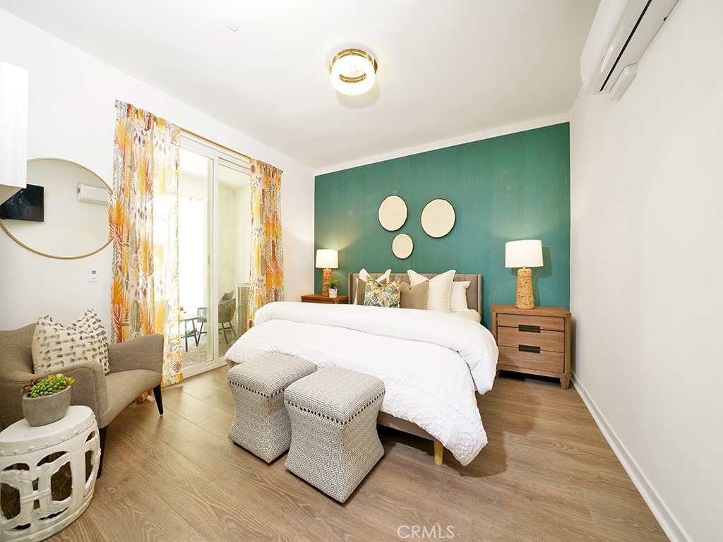 603 Shadowbrook Lake Forest, CA 92610 - Photo 18 of 23 a bedroom with a bed and wooden floor