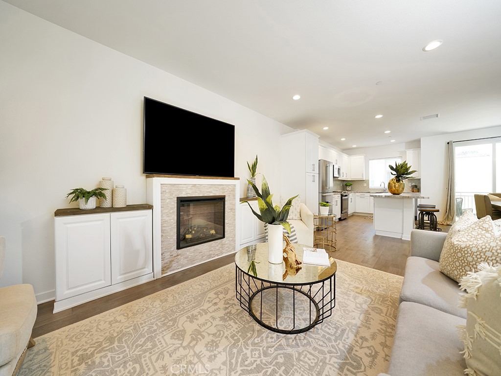 603 Shadowbrook Lake Forest, CA 92610 - Photo 3 of 23 a living room with furniture a fireplace and a flat screen tv