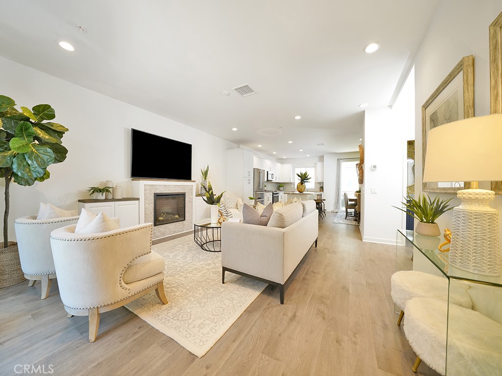 603 Shadowbrook Lake Forest, CA 92610 - Photo 8 of 23 a living room with furniture a flat screen tv and a potted plant