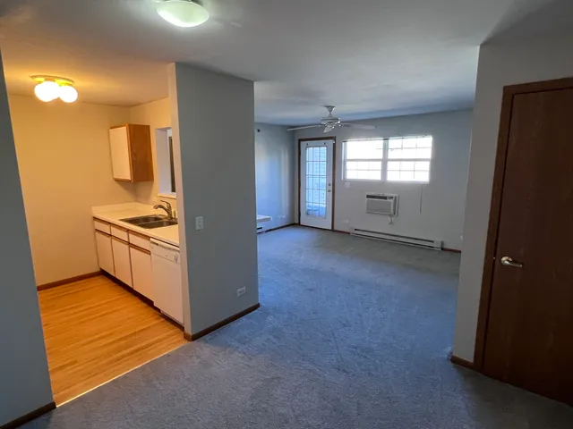a view of a kitchen with an empty space and a window