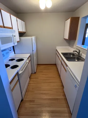 a kitchen with sink stove and cabinets