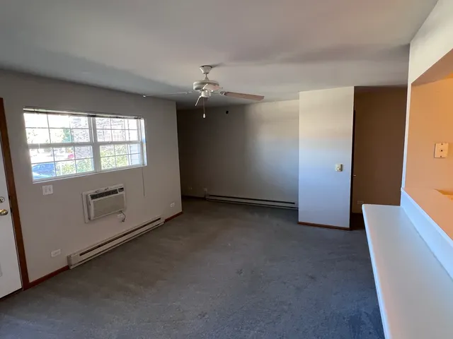 an empty room with windows and closet