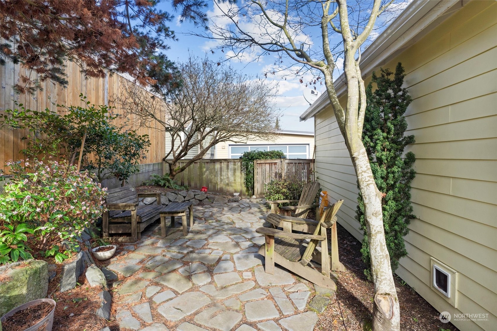 7209 Dayton Avenue North Seattle, WA 98103 - Photo 30 of 33 a view of a patio with table and chairs and potted plants