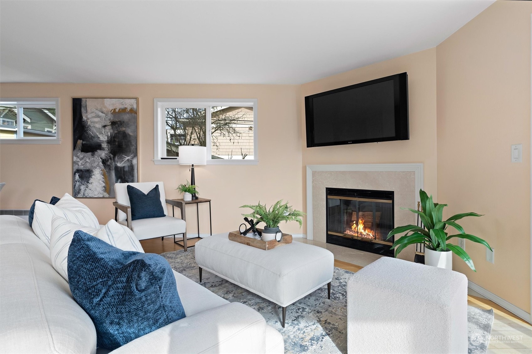 7209 Dayton Avenue North Seattle, WA 98103 - Photo 7 of 33 a living room with furniture a flat screen tv and a fireplace