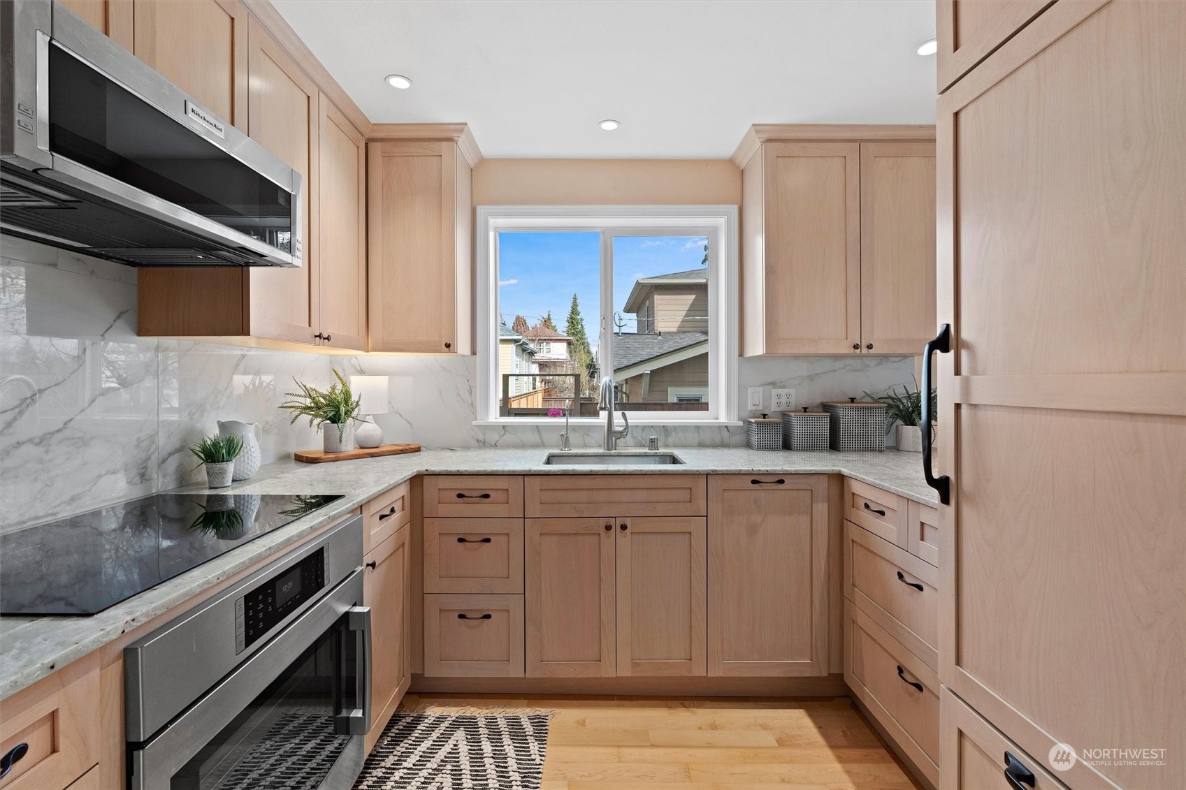 7209 Dayton Avenue North Seattle, WA 98103 - Photo 10 of 33 a kitchen with a sink dishwasher stove and white cabinets