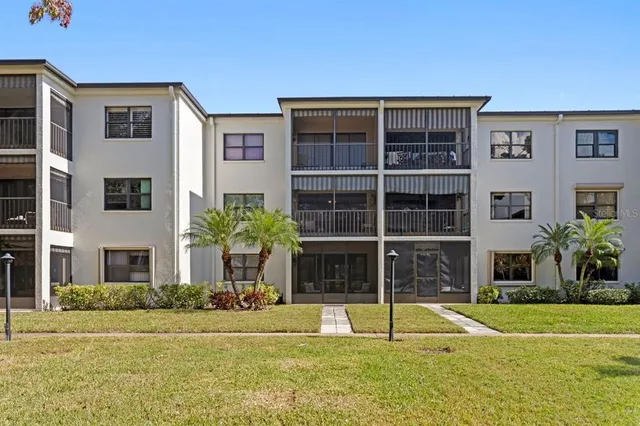 front view of a house with a big yard and potted plants