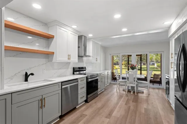a kitchen with sink cabinets and wooden floor