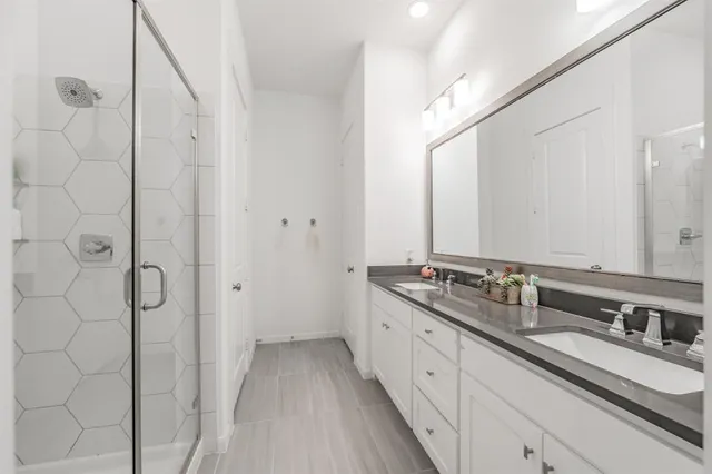 a spacious bedroom with a bed and a chandelier