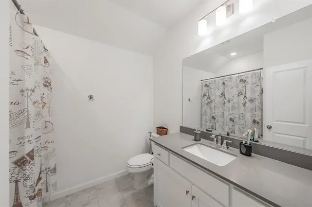 a bed room with a bed and a chair