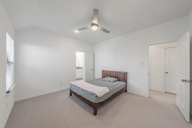 a bathroom with a granite countertop sink a mirror and a toilet