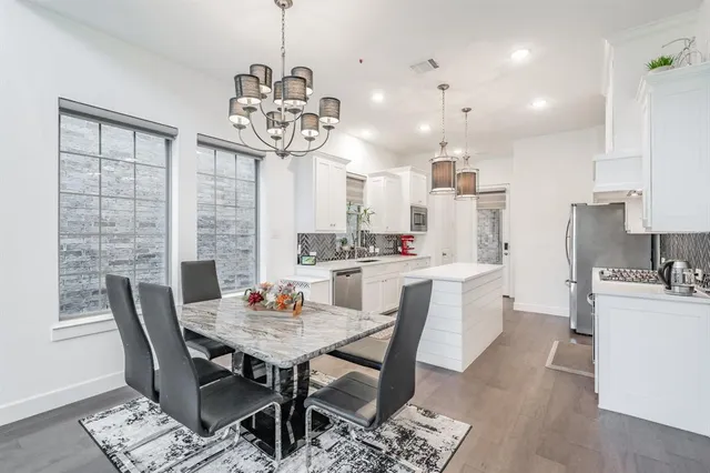 a living room with furniture and view of kitchen