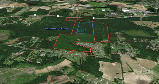 an aerial view of a residential houses with outdoor space and street view