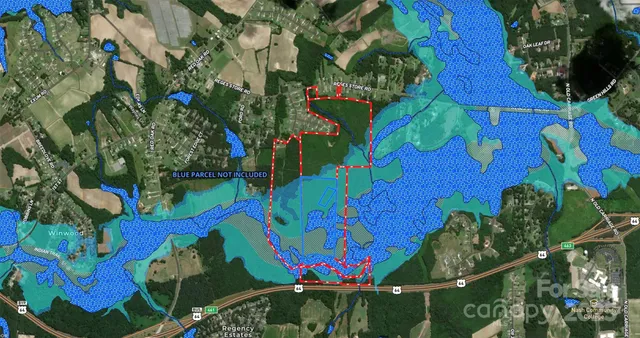 a view of a field of grass and trees