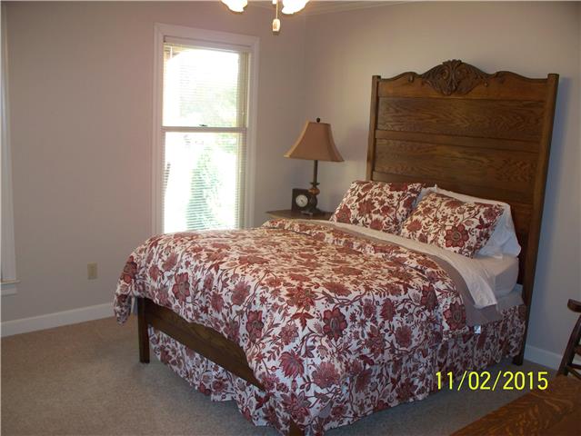 4809 Manners Road Lebanon, TN 37087 - Photo 15 of 19 a bed sitting in a bedroom next to a window