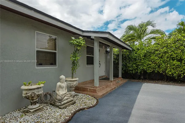 a backyard of a house with table and chairs