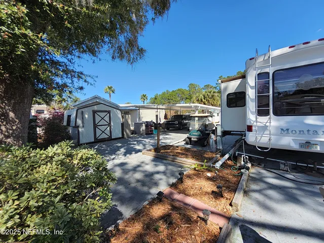 a view of house with backyard outdoor seating and covered with furniture