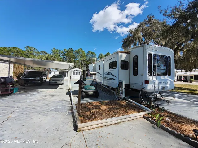 a view of a yard with cars