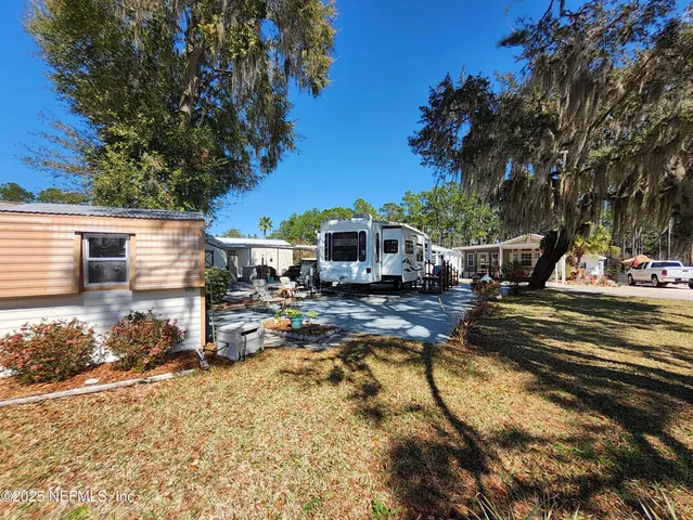 a view of a house with swimming pool and sitting area