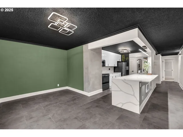 a view of kitchen with furniture and a potted plant
