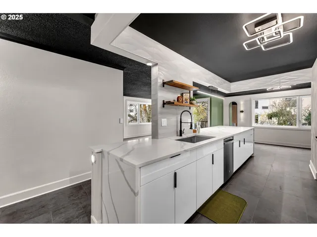 a large white kitchen with a sink