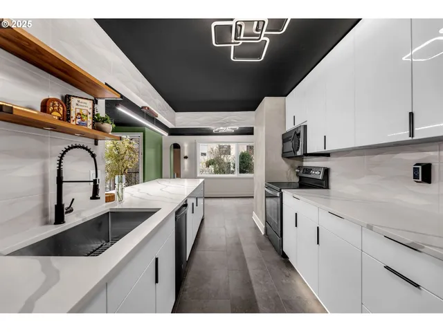 a kitchen with kitchen island sink stove and refrigerator