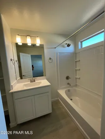a bathroom with a granite countertop sink a toilet and a mirror