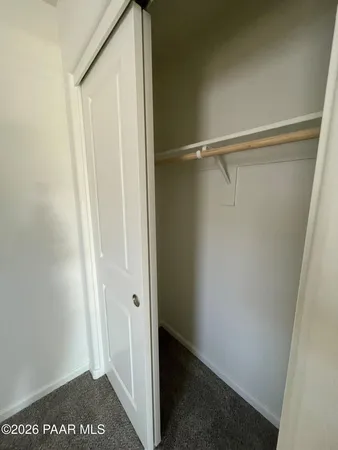 a view of a dry yard with wooden fence