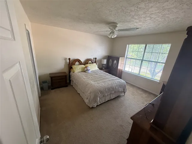 a bedroom with a bed and window