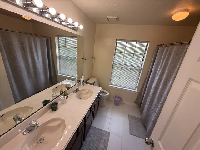 a bathroom with a tub sink and mirror