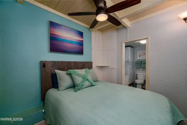 a bed room with a bed and a painting on the wall