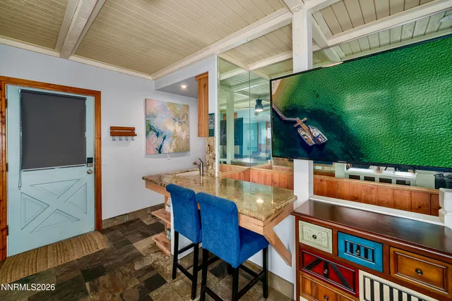 a dining room with furniture and a rug