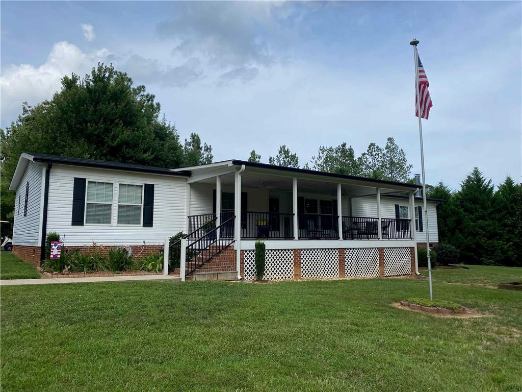 383 Gillis Road Roxboro, NC 27574 - Photo 1 of 19 a front view of a house with a garden and yard