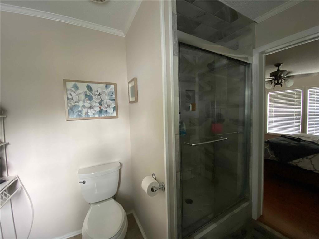 383 Gillis Road Roxboro, NC 27574 - Photo 11 of 19 a bathroom with a toilet and a shower
